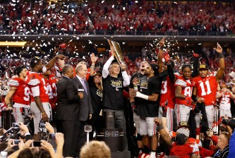 ARLINGTON, TX - JANUARY 12:  Head Coach Urban Meyer of the Ohio State Buckeyes hoist the trophy after defeating the Oregon Ducks 42 to 20 in the College Football Playoff National Championship Game at AT&T Stadium on January 12, 2015 in Arlington, Texas.  (Photo by Christian Petersen/Getty Images)