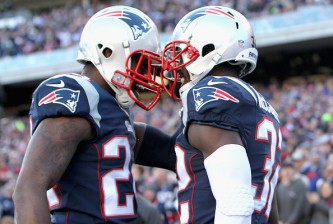FOXBORO, MA - DECEMBER 14:  Darrelle Revis #24 and Devin McCourty #32 of the New England Patriots react after McCourty broke up a pass during the first quarter against the Miami Dolphins at Gillette Stadium on December 14, 2014 in Foxboro, Massachusetts.  (Photo by Jim Rogash/Getty Images)
