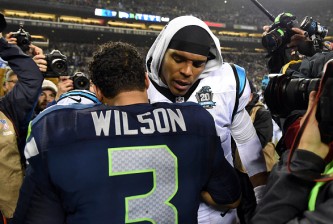 SEATTLE, WA - JANUARY 10:  Russell Wilson #3 of the Seattle Seahawks shakes hands with Cam Newton #1 of the Carolina Panthers after their 2015 NFC Divisional Playoff game at CenturyLink Field on January 10, 2015 in Seattle, Washington. The Seattle Seahawks defeated the Carolina Panthers 31 to 17.(Photo by Steve Dykes/Getty Images)
